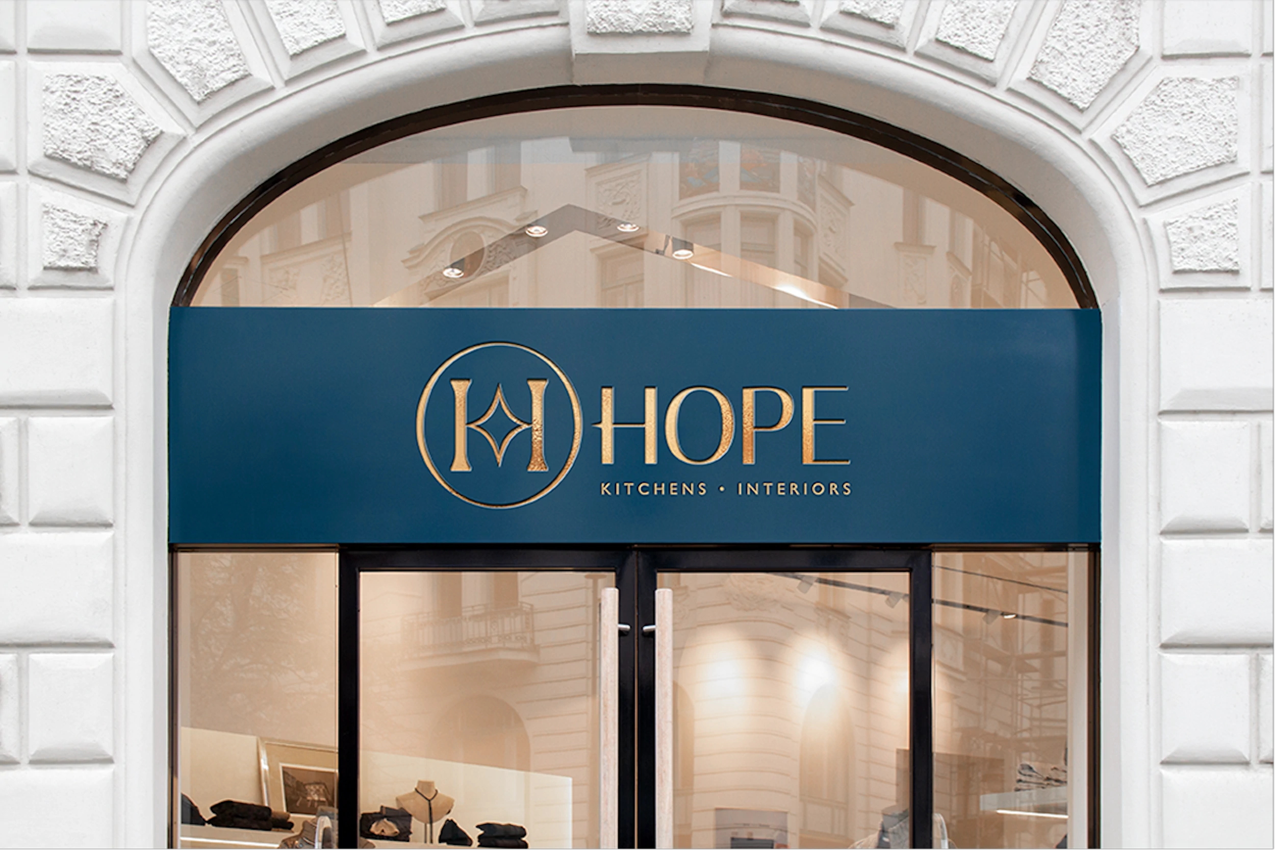 Hope Kitchens and Interiors shop sign in gold lettering on a navy fascia above a showroom window
