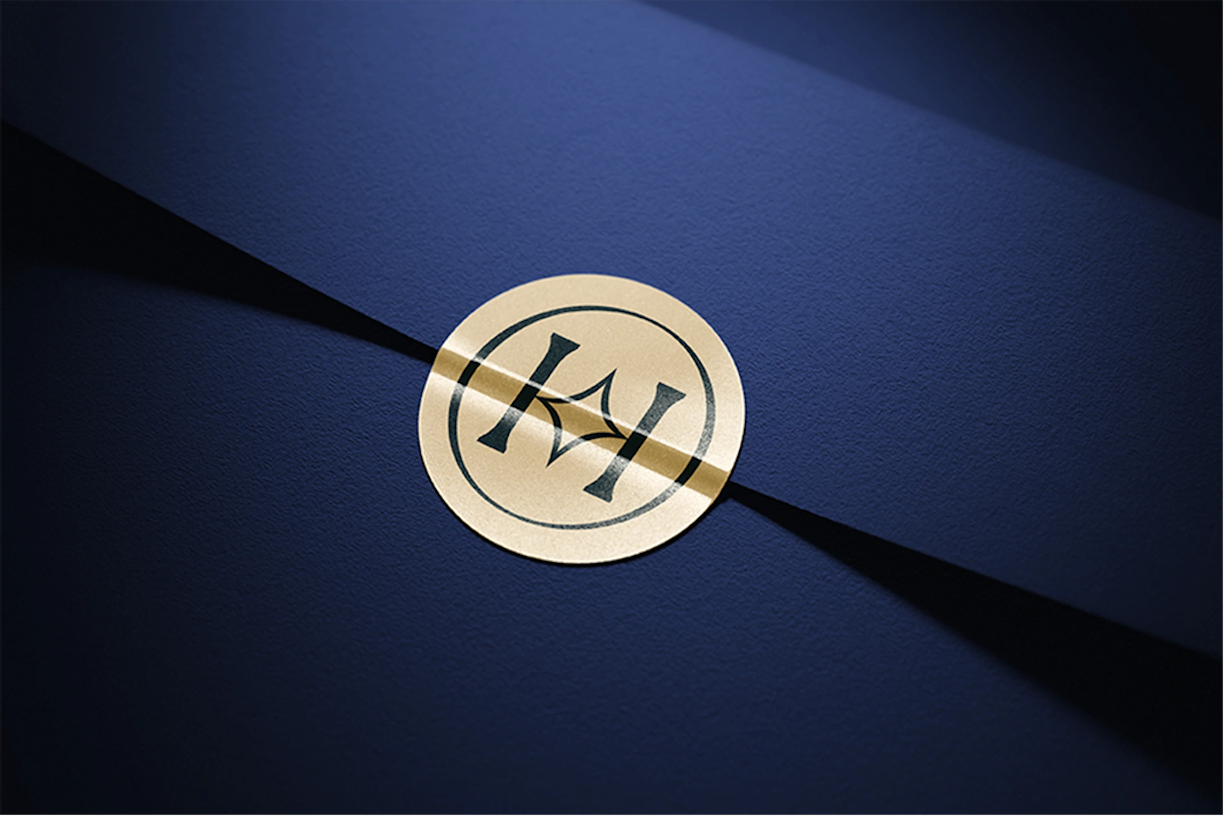 Round gold sticker with the Hope star monogram on navy textured paper